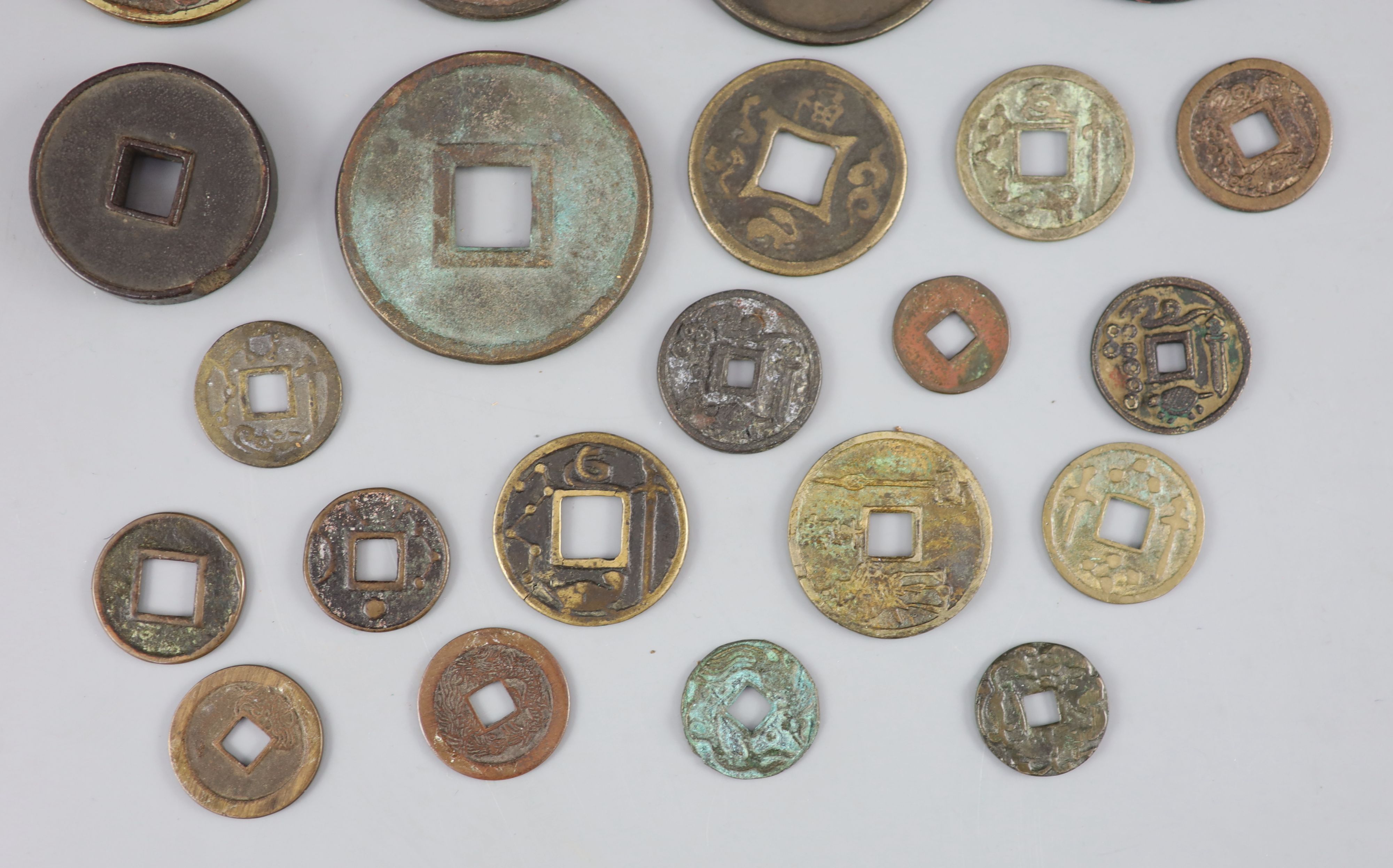 China, a group of 6 bronze coin charms or amulets, 19th century and various Thai (Siamese) porcelain gaming counters,